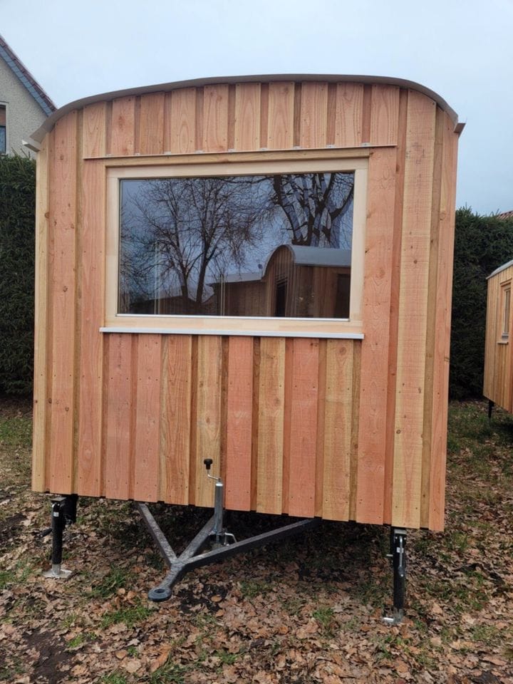 20 foot mobile trailer with door and window covered in wood