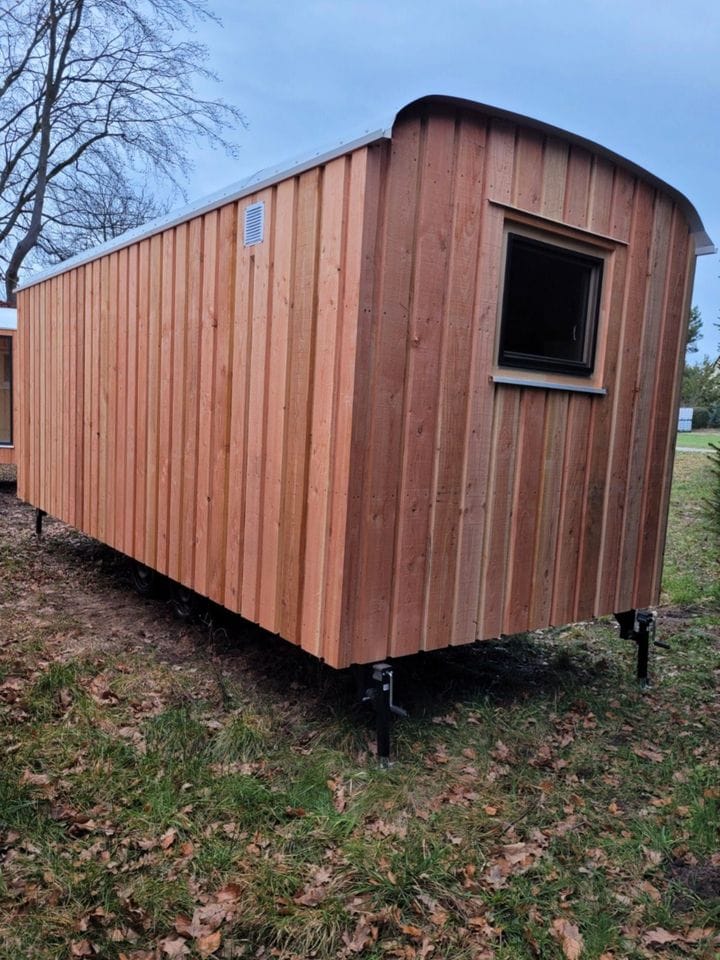 20 foot mobile trailer with door and window covered in wood