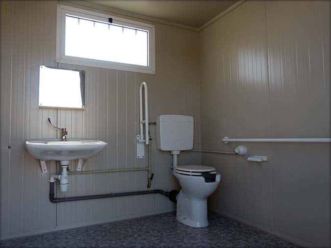 Spacious sanitary cabin with toilet and shower