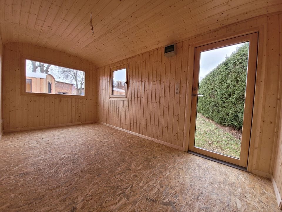 20 foot mobile trailer with door and window covered in wood