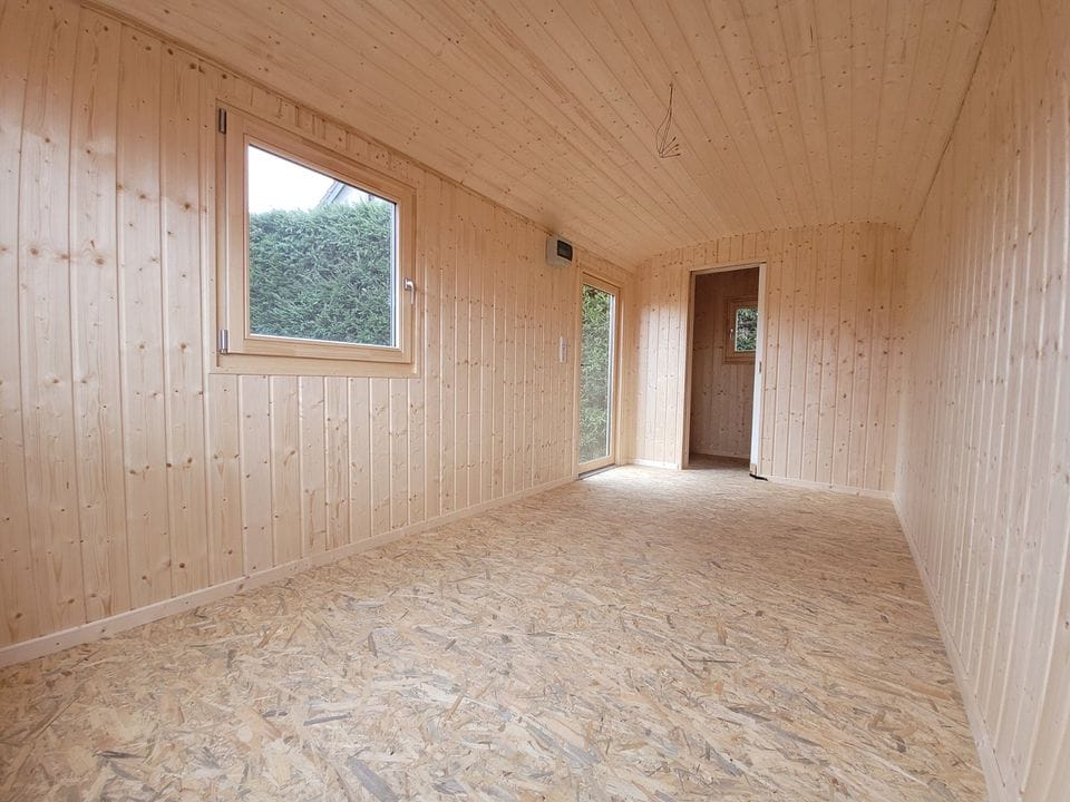 20 foot mobile trailer with door and window covered in wood