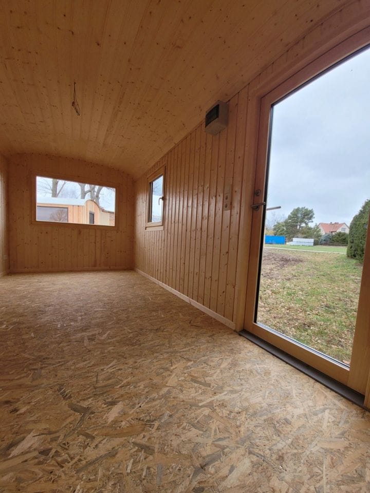 20 foot mobile trailer with door and window covered in wood