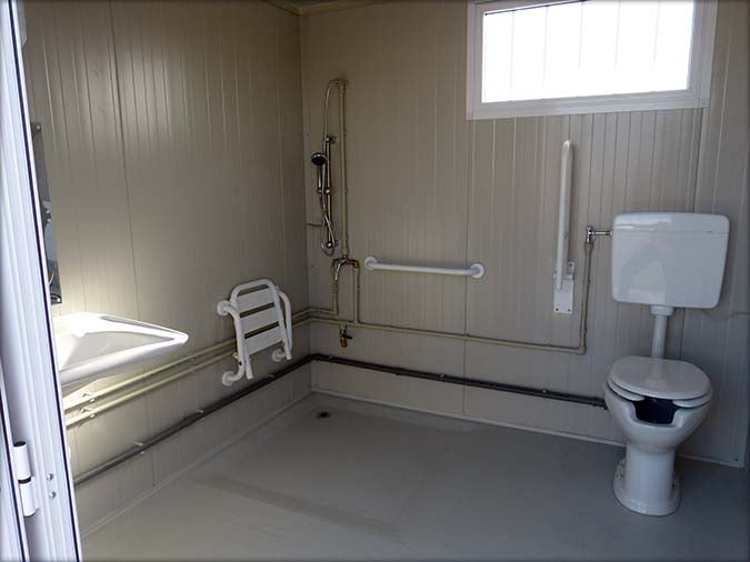 Spacious sanitary cabin with toilet and shower