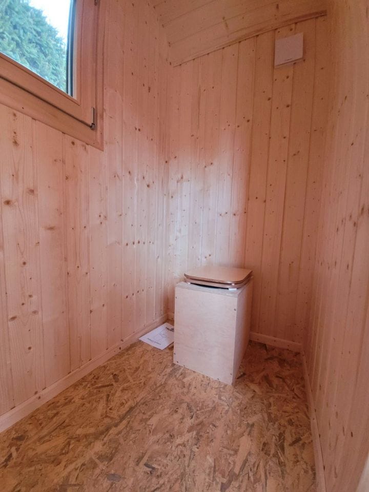 20 foot mobile trailer with door and window covered in wood