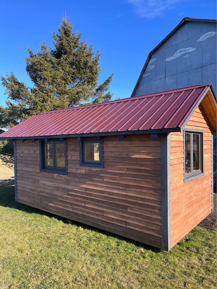 20 x 8 foot mobile home, covered in used wood, steel roof, furnished and comfortable