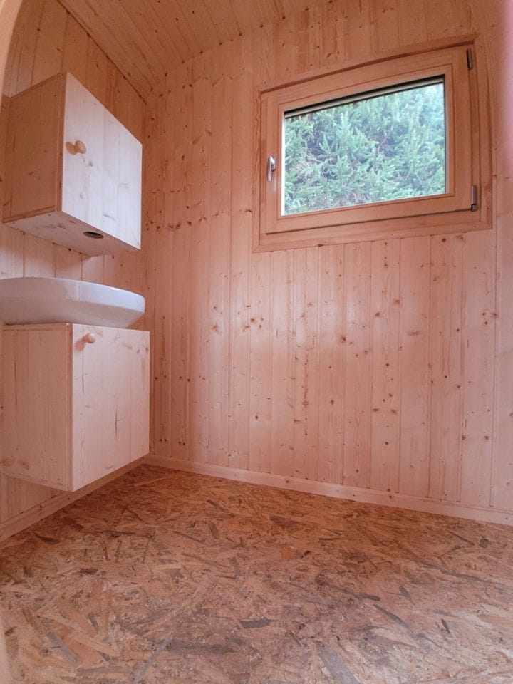 20 foot mobile trailer with door and window covered in wood