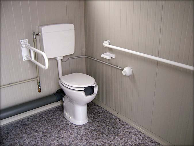 Spacious sanitary cabin with toilet and shower
